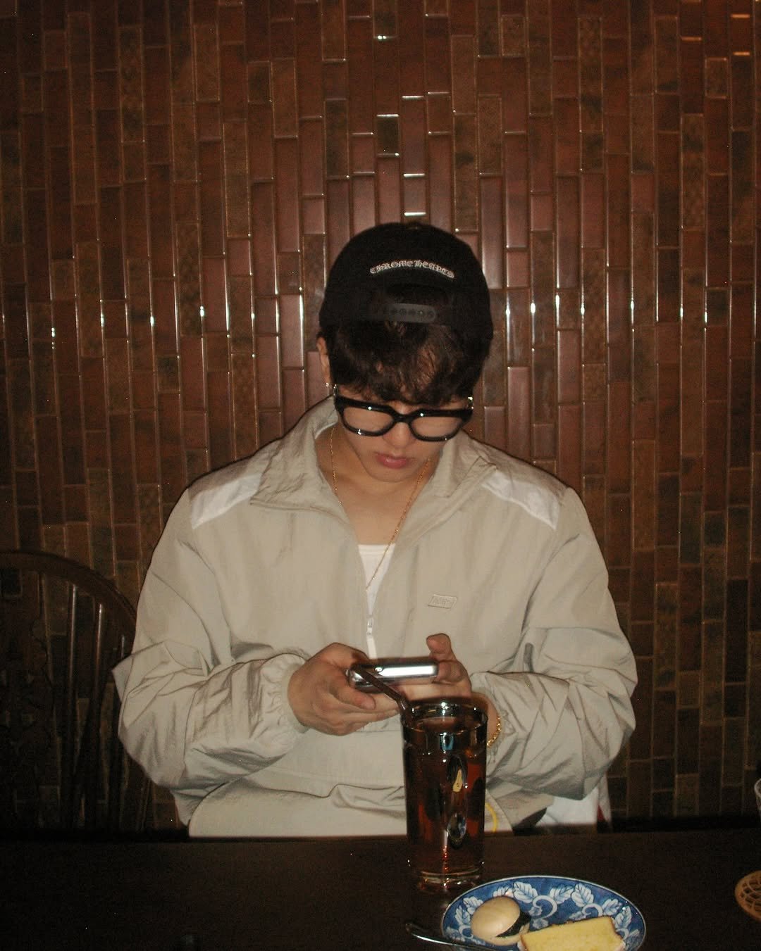 Photo by CHANGBIN on March 11, 2026. May be an image of one or more people, bangs, phone, beer, duffle coat, hat, cigarette, beret, bolo tie, parka and text.