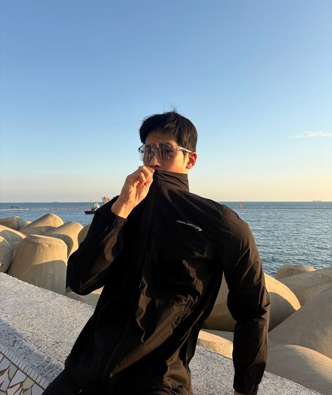 Photo shared by 이준한 on November 25, 2025 tagging @hdex__official. May be an image of parka, flight jacket, ocean and text.