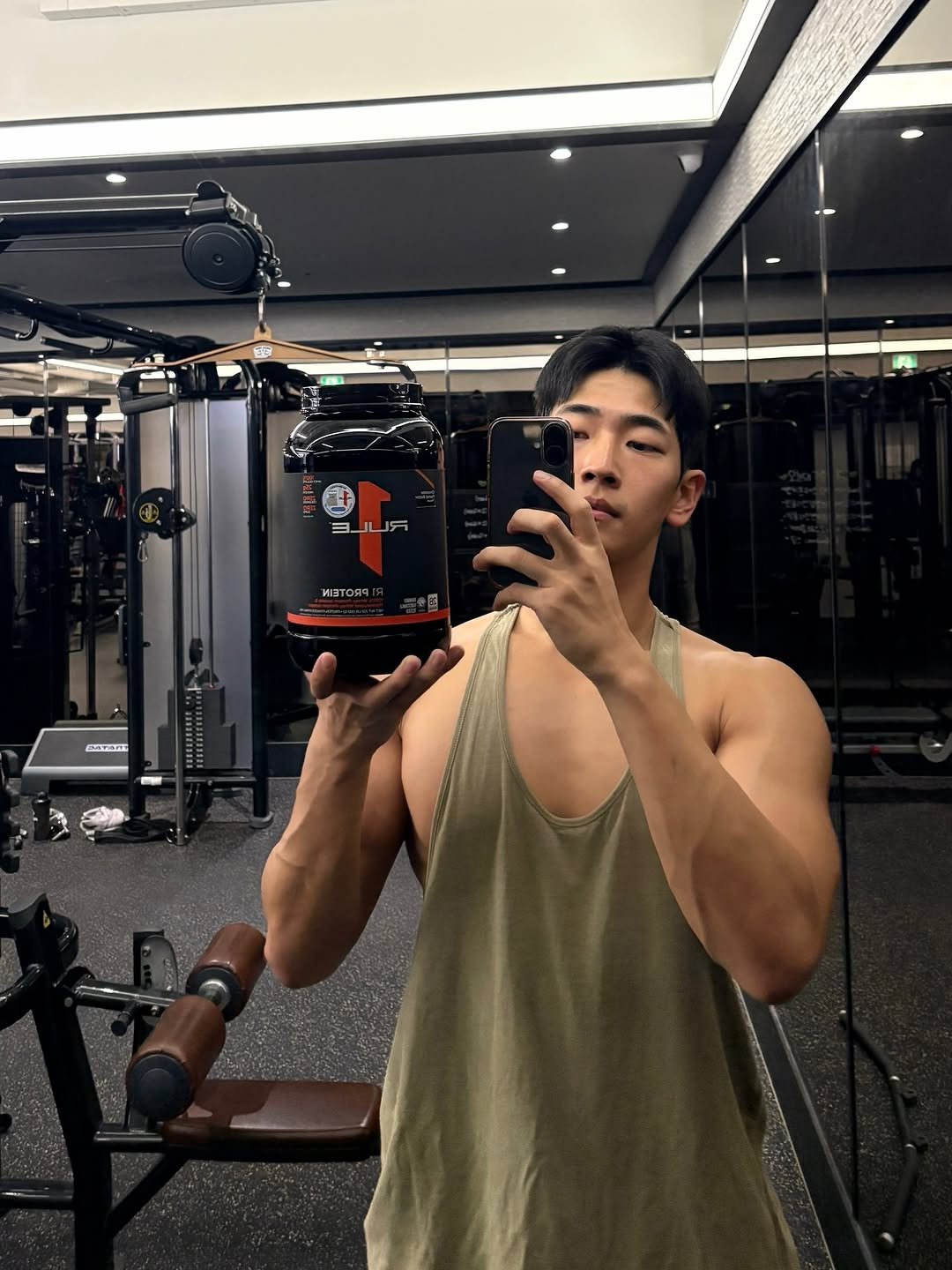 Photo shared by 이준한 on November 17, 2025 tagging @ruleoneproteins_kr. May be an image of one or more people, biceps, people bodybuilding, tanktop, dumbbell and text.