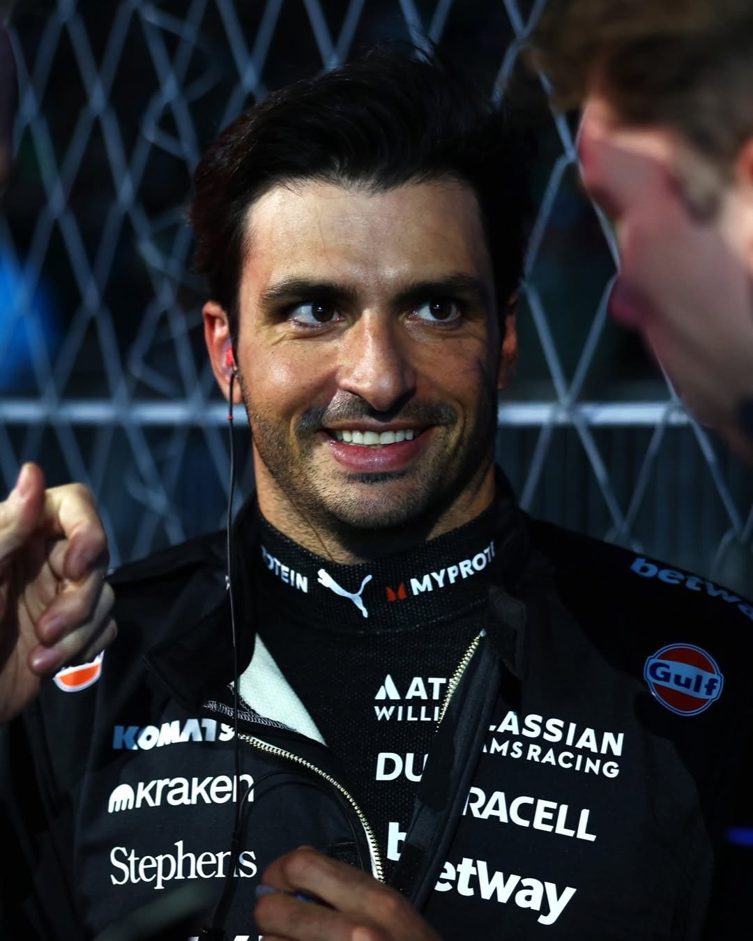 Photo shared by James Vowles on November 23, 2025 tagging @carlossainz55. May be an image of ‎racing vehicles, race car, helmet and ‎text that says '‎לווי מר MYPRO MYPRO COMATS MAΤ AAT AT WILLE mKraken? Gulf DU MSRACING .ASSIAN t RACELL etway Stepher S‎'‎‎.