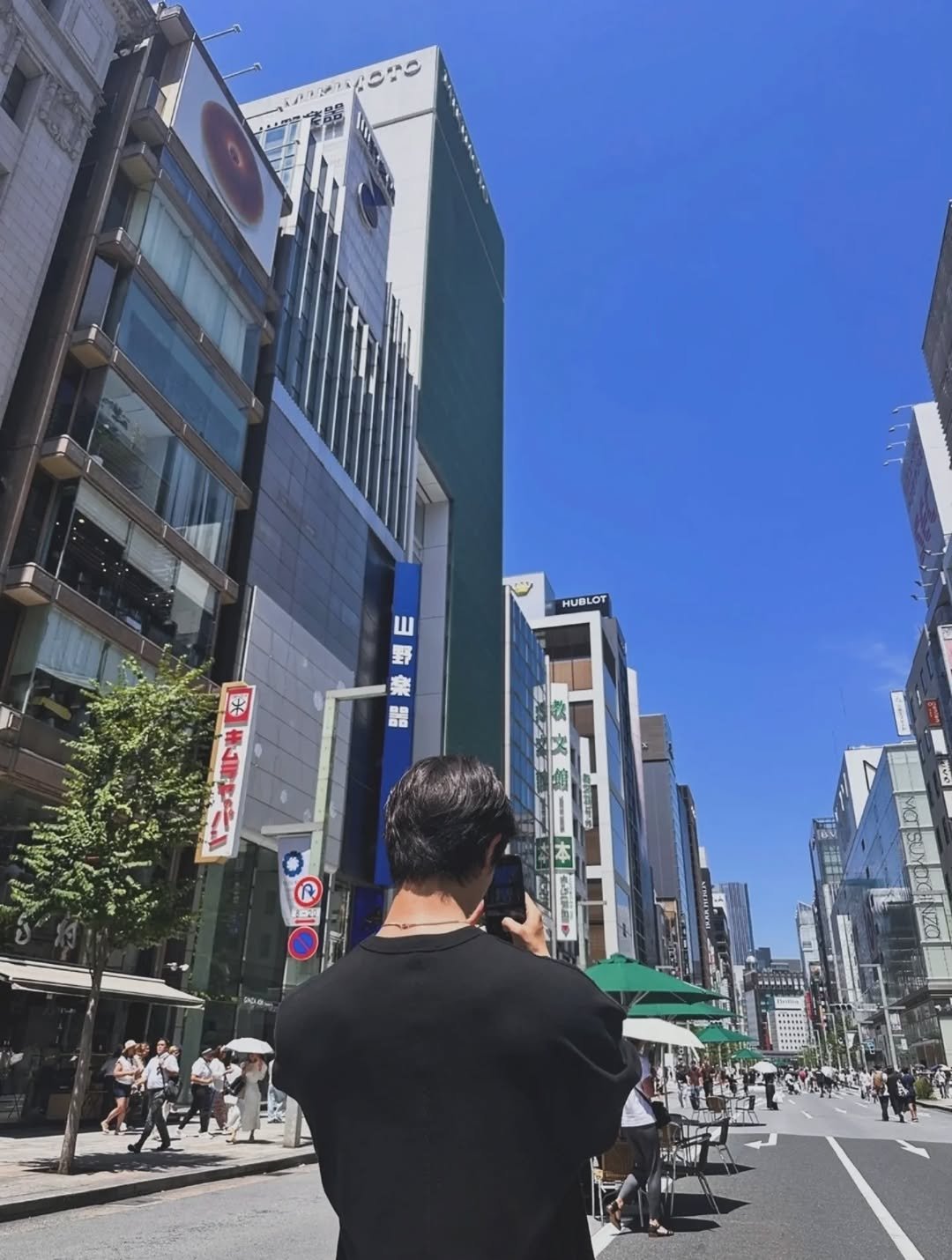 Photo by DH_K on July 29, 2025. May be an image of 8 people, street, Times Square, skyscraper and text.