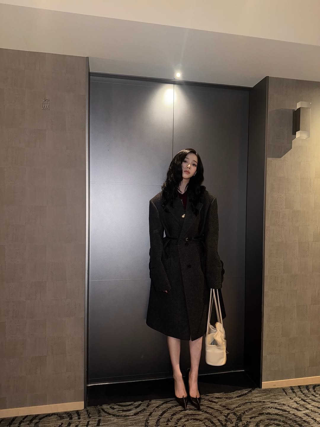 Photo shared by KARINA on October 31, 2025 tagging @prada. May be an image of overcoat, sable coat and duffle coat.