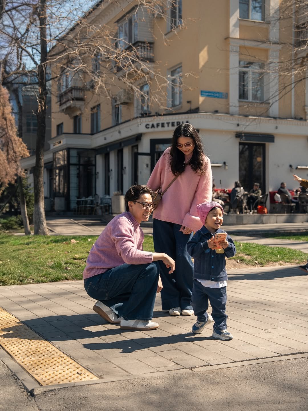 Photo shared by Madina Janiyeva🕊️💕 on April 20, 2026 tagging @kbeklan. May be an image of child, standing, fleece, street, grass, park and text.