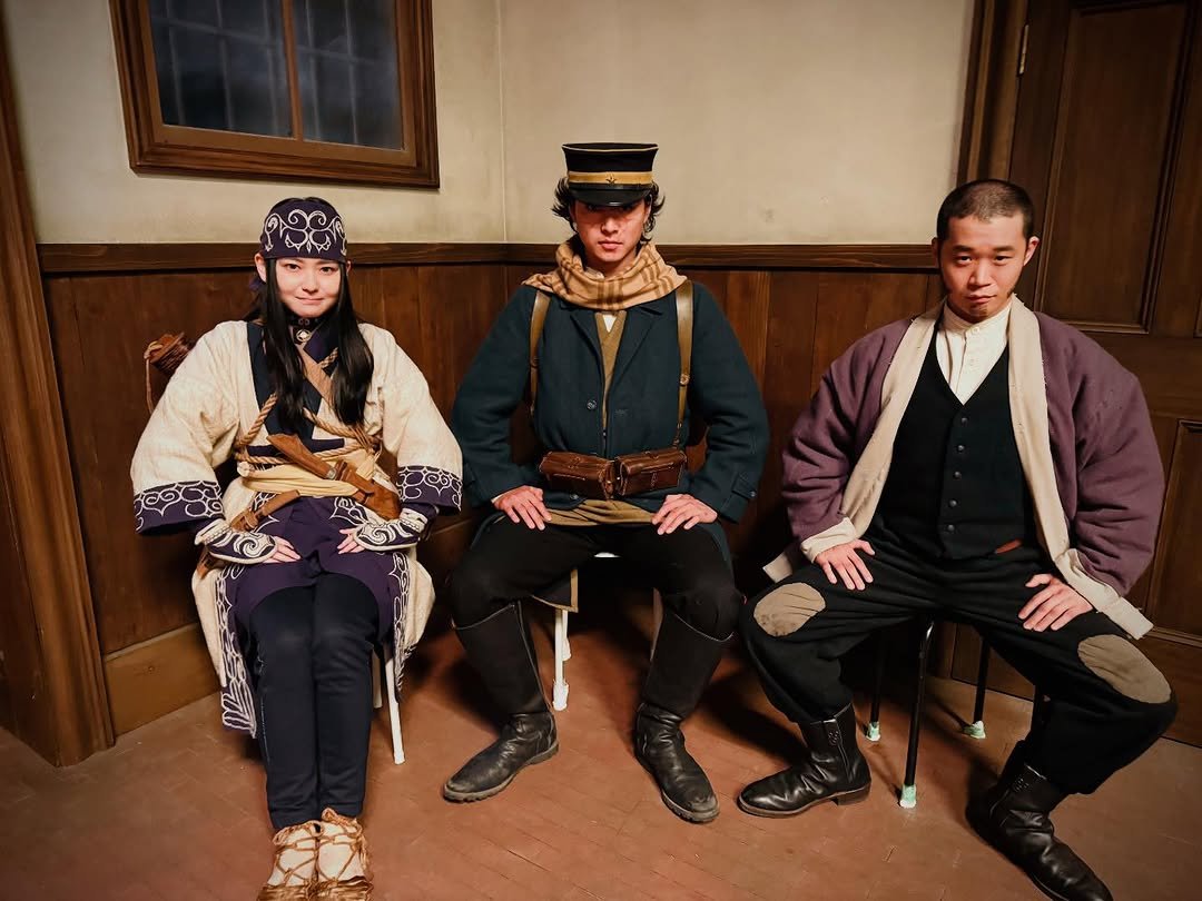 Photo shared by 山﨑賢人 on March 21, 2026 tagging @anna_yamada_, @yuma_yamoto.official, and @kamuy_movie. May be an image of kilt, military uniform, sword, cloak, glasses, costume and text.