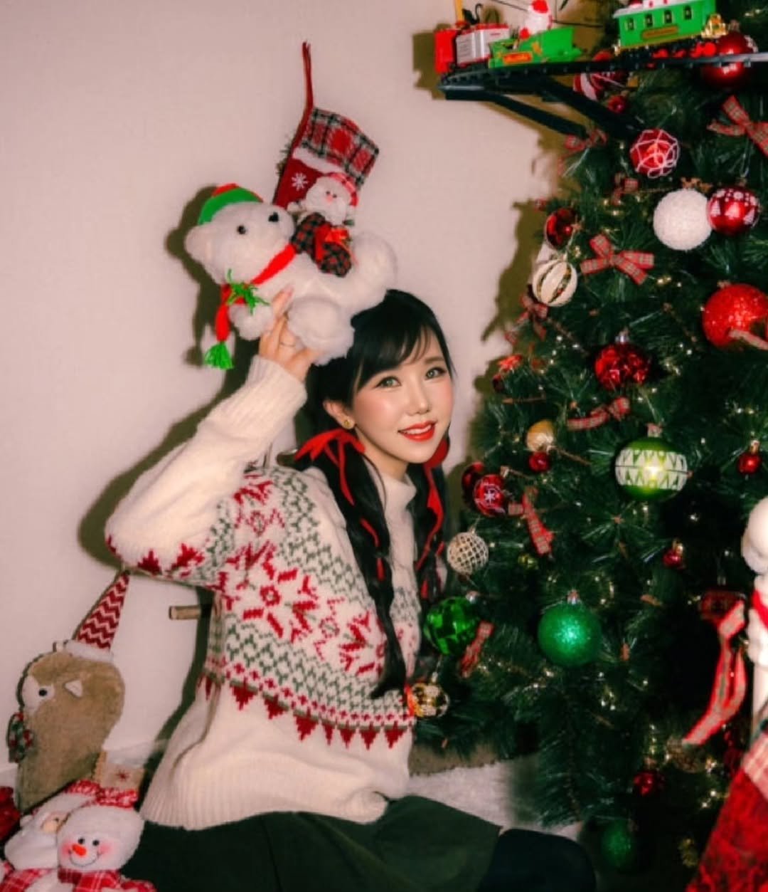 Photo by 김다나 on December 22, 2025. May be an image of one or more people, hair, christmas tree, tinsel, snowman, sweater and text.