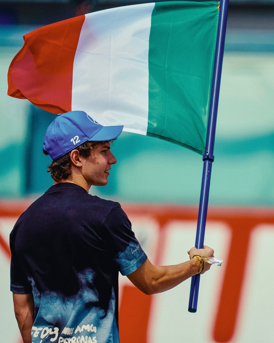 Photo by Andrea Kimi Antonelli on April 20, 2026. May be an image of tennis, flag, racket, stadium and text.