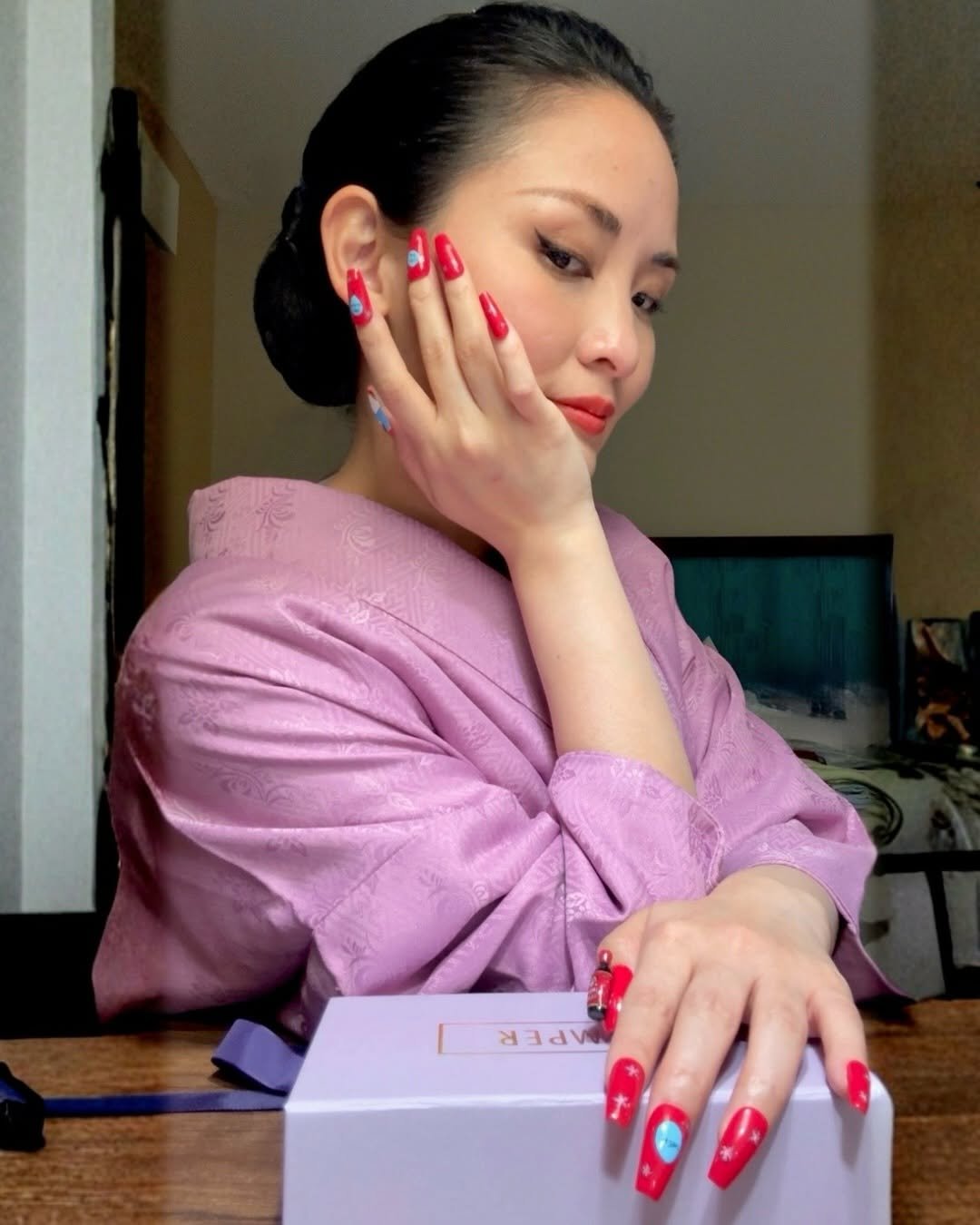 Photo shared by MOE／Kimono Mom on February 16, 2026 tagging @japagel_nails, and @umami_kimonomom. May be an image of one or more people, fingernails, makeup, robe, bath robe and text.
