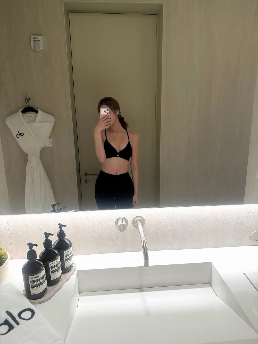 Photo shared by KISS OF LIFE on February 04, 2026 tagging @alo. May be an image of bra, bathtub, shower, mirror and text.