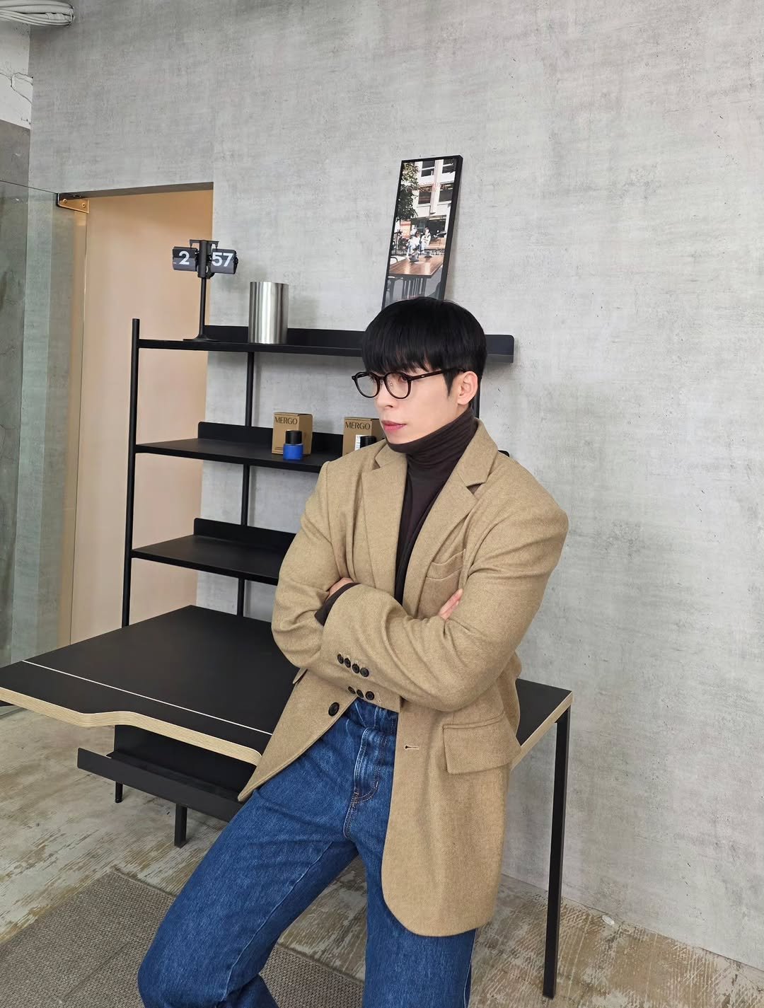 Photo by Daeheon Kang on December 11, 2025. May be an image of duffle coat, overcoat, suit, eyeglasses, turtleneck, blazer, cornflower and text.
