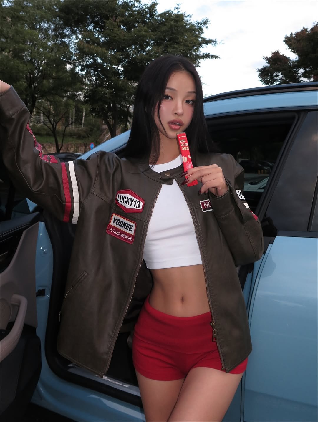 Photo shared by 강경민 on October 22, 2025 tagging @dr_labnosh. May be an image of bubble gum, flight jacket, miniskirt, cigarette and text.