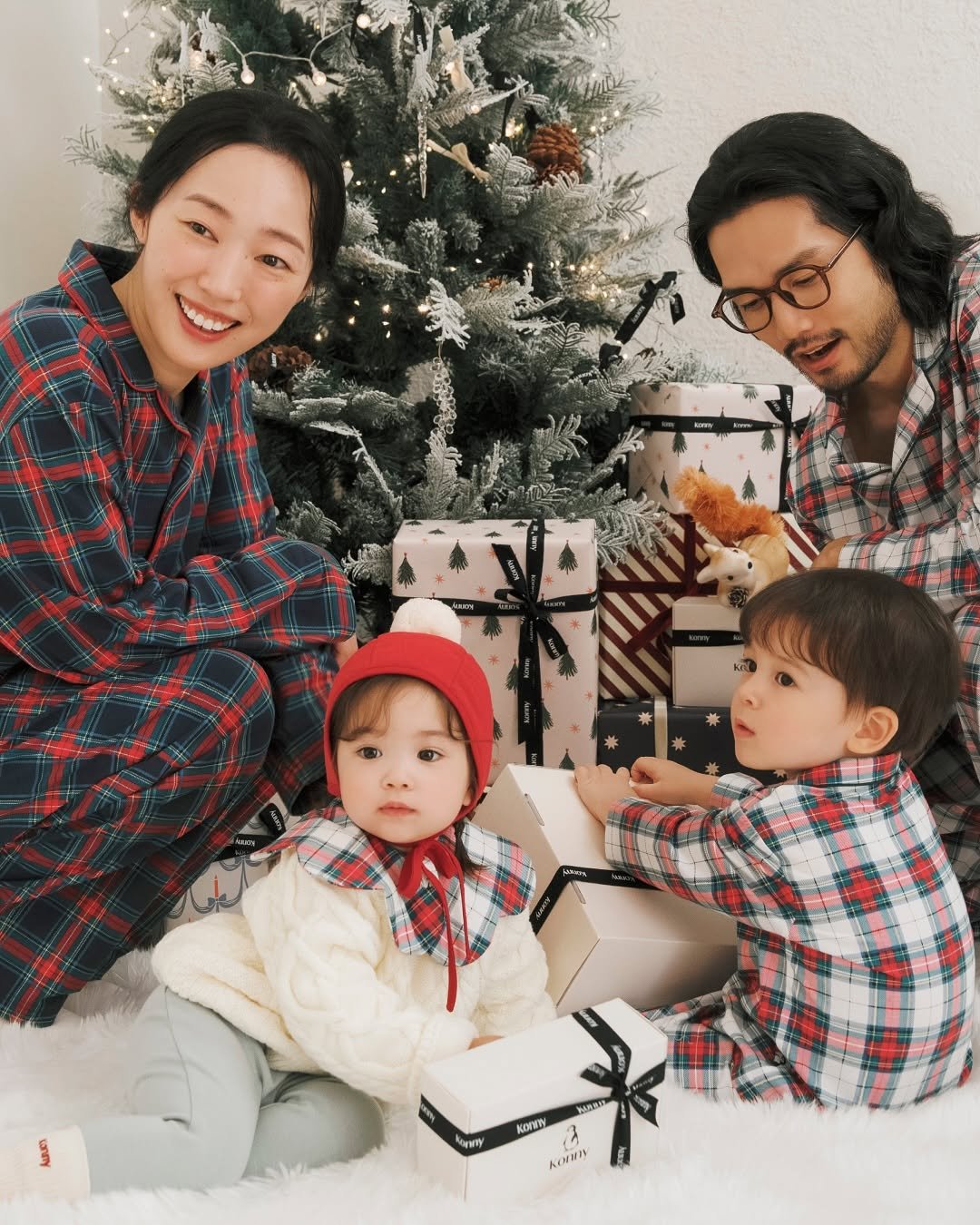 Photo by Konny l 코니 on November 04, 2025. May be an image of baby, sleepwear, christmas tree and text.