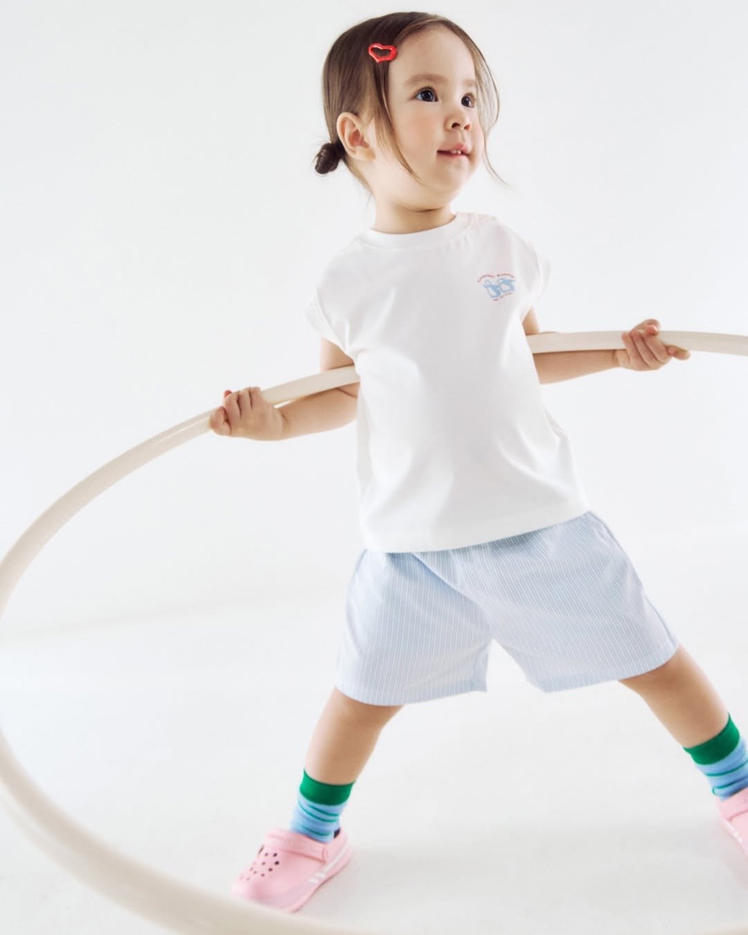 Photo by Konny l 코니 on April 14, 2026. May be an image of child, sleepwear, baby shoes, shorts, sock and text.