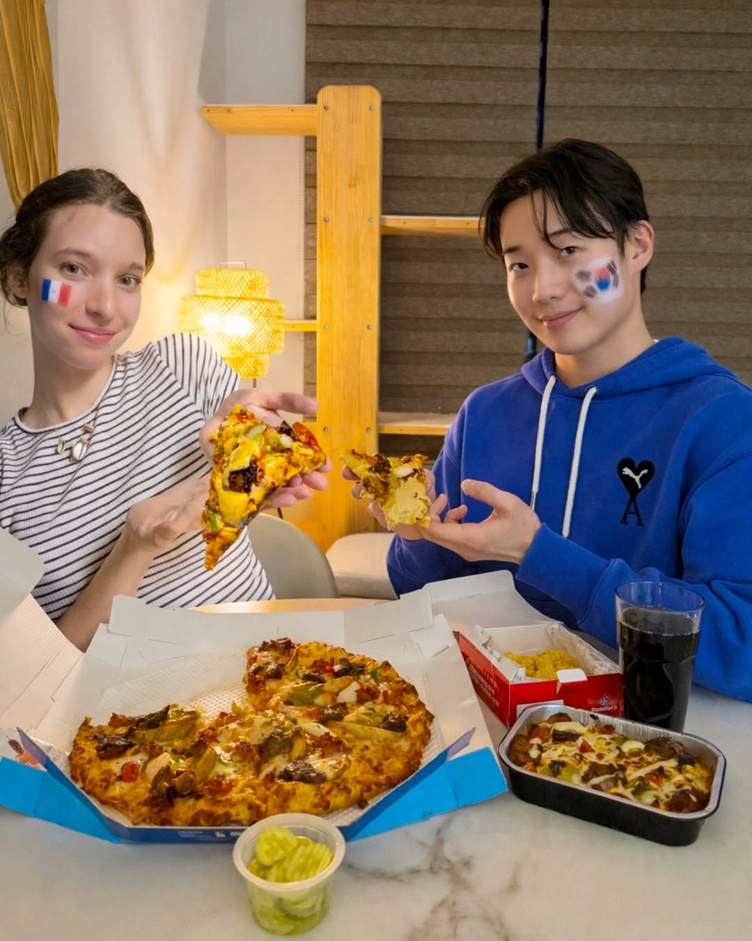 Photo shared by 도미노피자 공식 인스타그램 on February 09, 2026 tagging @korfracouple. May be an image of pizza and text.