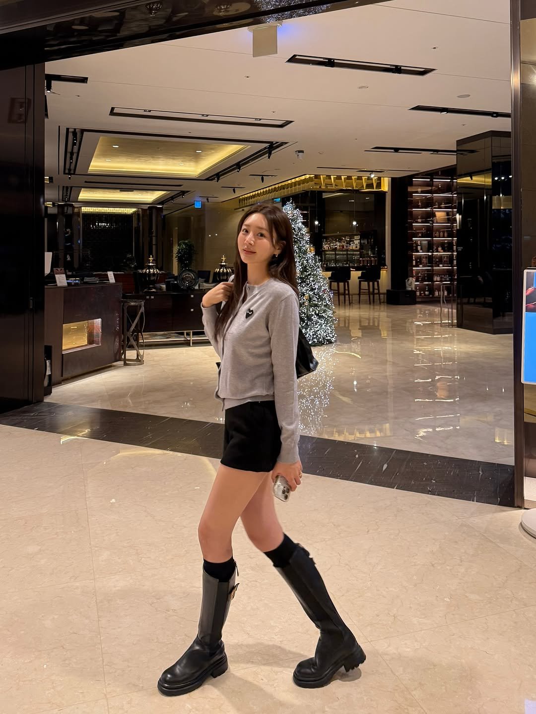 Photo by 권슈나 on December 18, 2025. May be an image of miniskirt, boots and text.