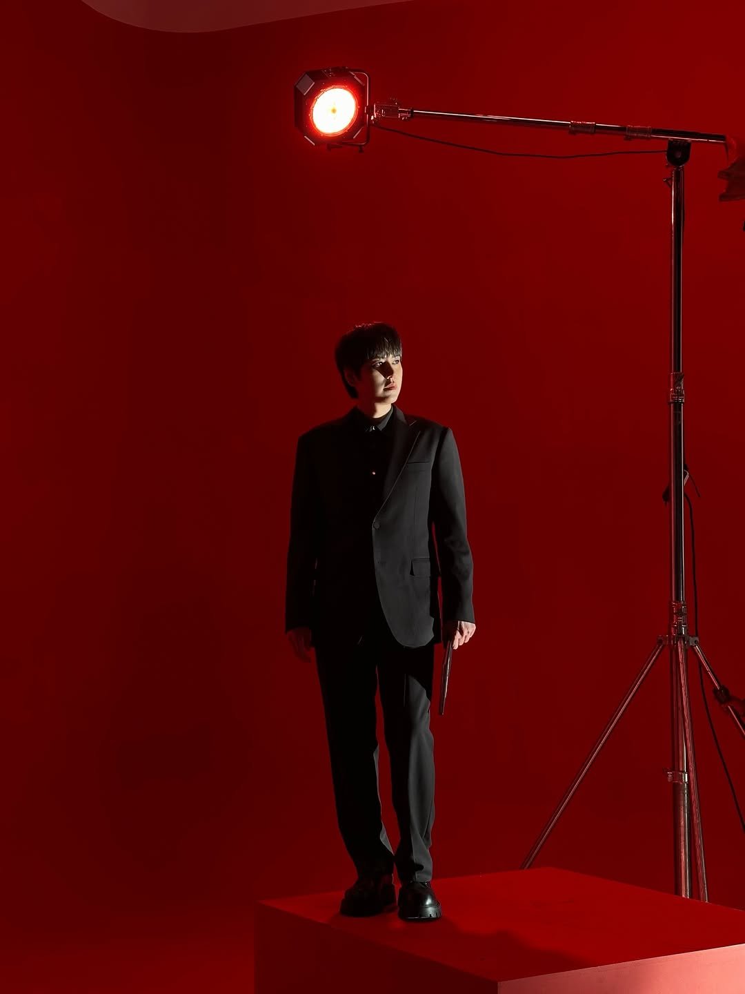 Photo by 규현 KYUHYUN on January 06, 2026. May be an image of lighting, suit, microphone, dinner jacket and text.