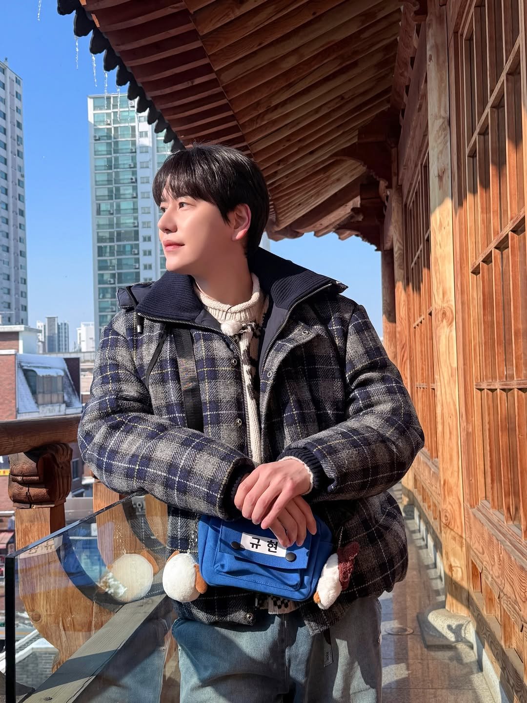 Photo shared by 안테나 Antenna on February 15, 2026 tagging @gyuram88, and @kyuhyun_official. May be an image of overcoat, goosedown coat, duffle coat, jacket, parka, Gyeongbokgung Palace and text.