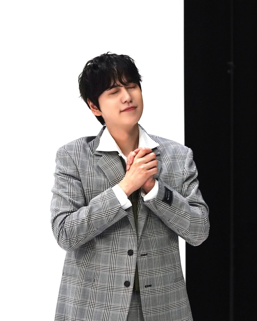 Photo by 규현 KYUHYUN on December 02, 2025. May be an image of one or more people, bangs, bolo tie, top, concert and text.