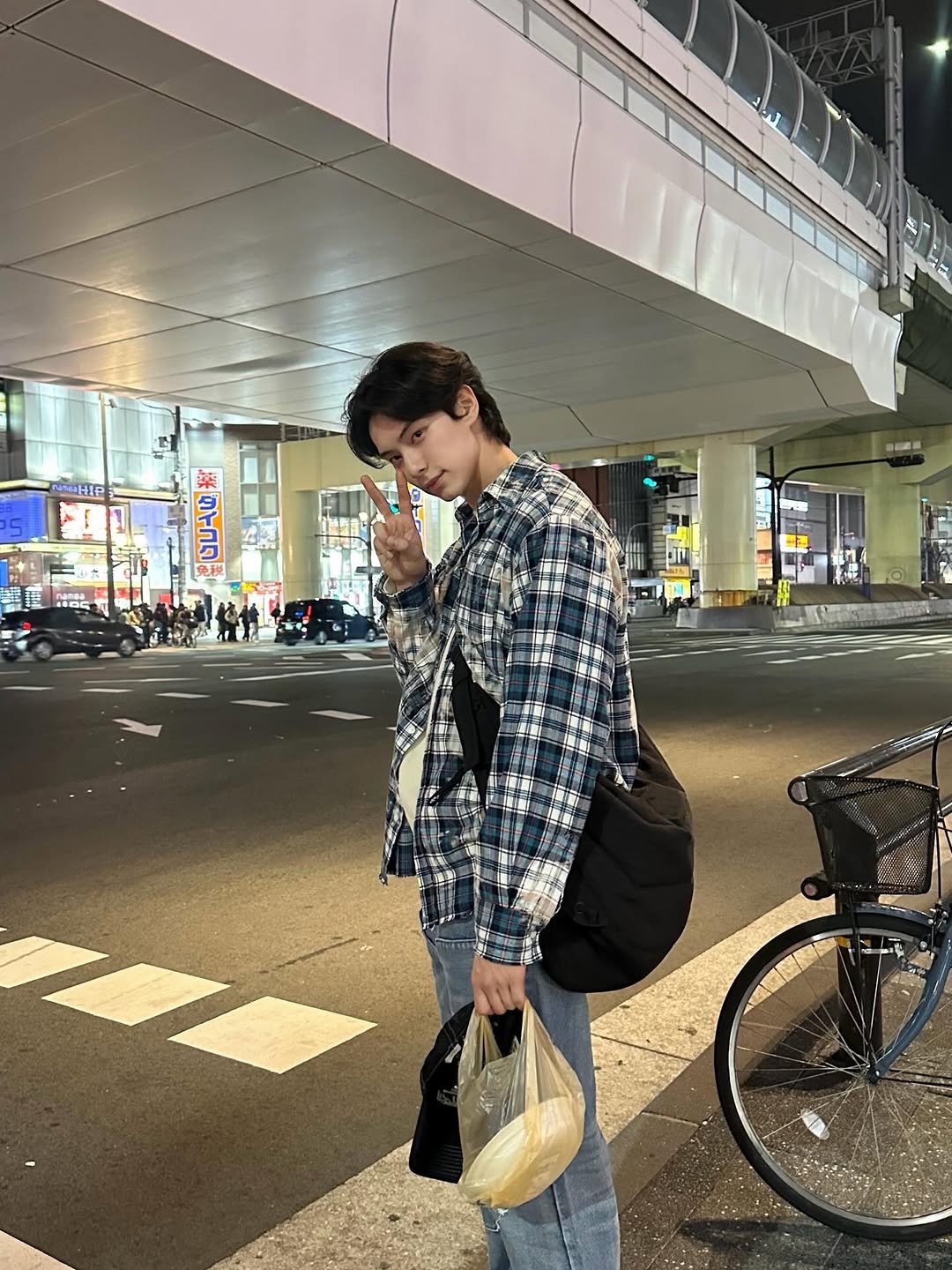 Photo by 이채민 Lee Chae Min 李彩玟 on January 21, 2026. May be an image of duffle coat, flannel, cigarette, street, night and text that says 'NWHIP #ጠኑት'.