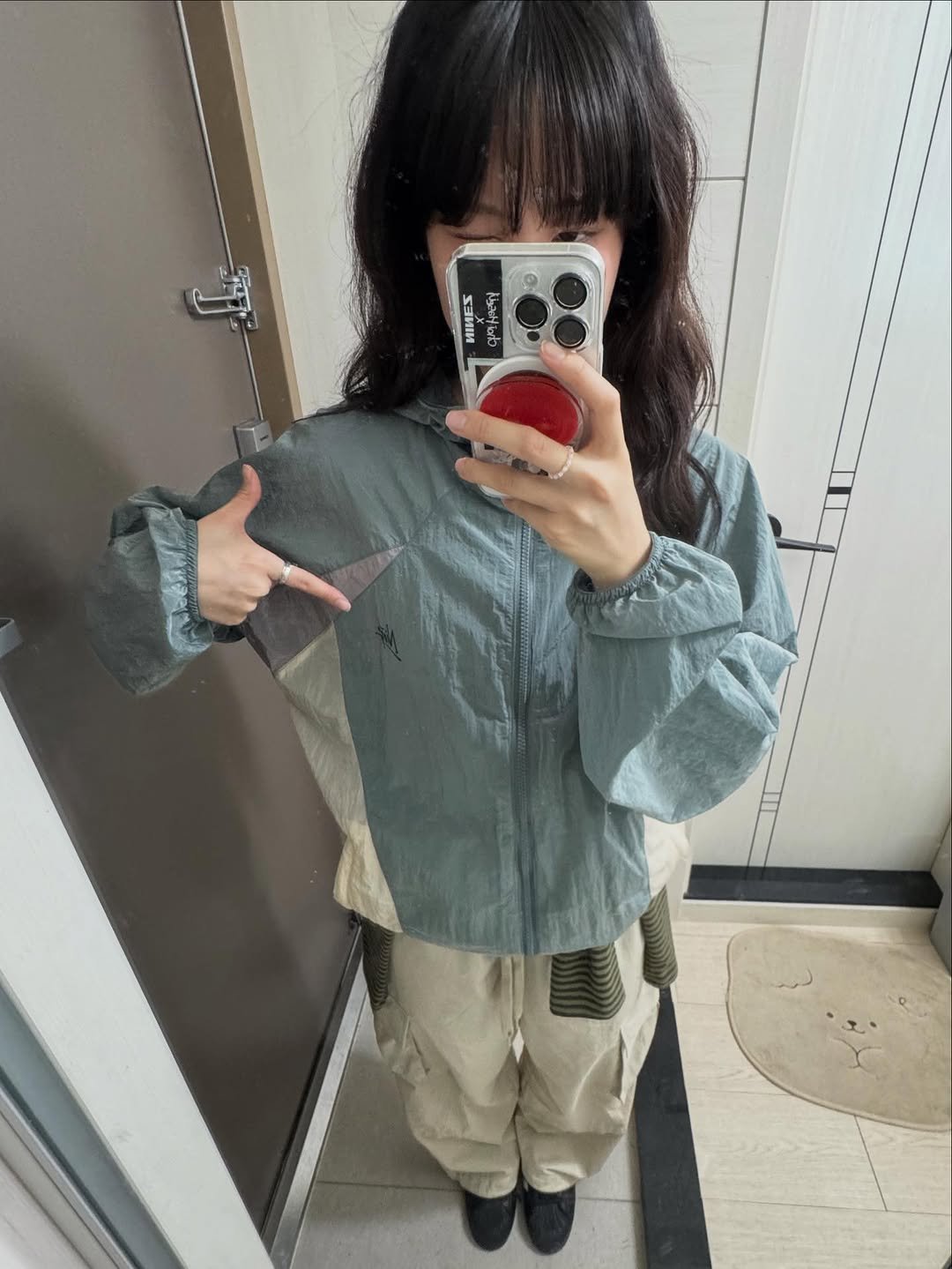 Photo shared by 최하슬 on September 28, 2025 tagging @ninez_official. May be an image of military uniform, parka, clothes hanger and text.