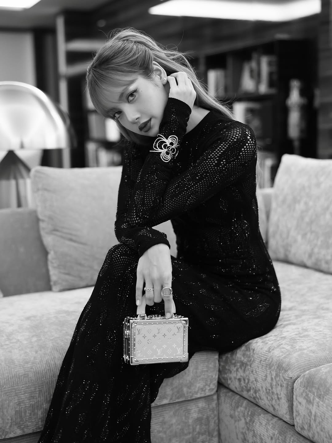 Photo shared by LISA on October 02, 2025 tagging @louisvuitton. May be a black-and-white image of 1 person, makeup, hair, dress and text.