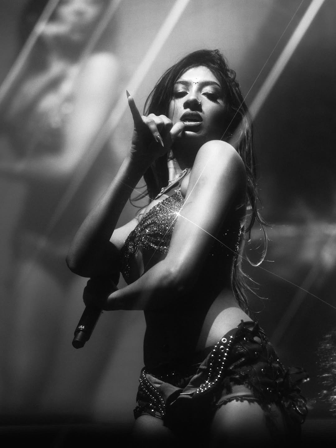 Photo shared by LARA RAJ on December 18, 2025 tagging @rahulb91, and @katieqian. May be a black-and-white image of fishnet stockings, concert and text.