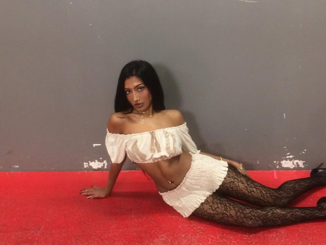 Photo by LARA RAJ on December 08, 2025. May be an image of one or more people, makeup, fishnet stockings, miniskirt and text.