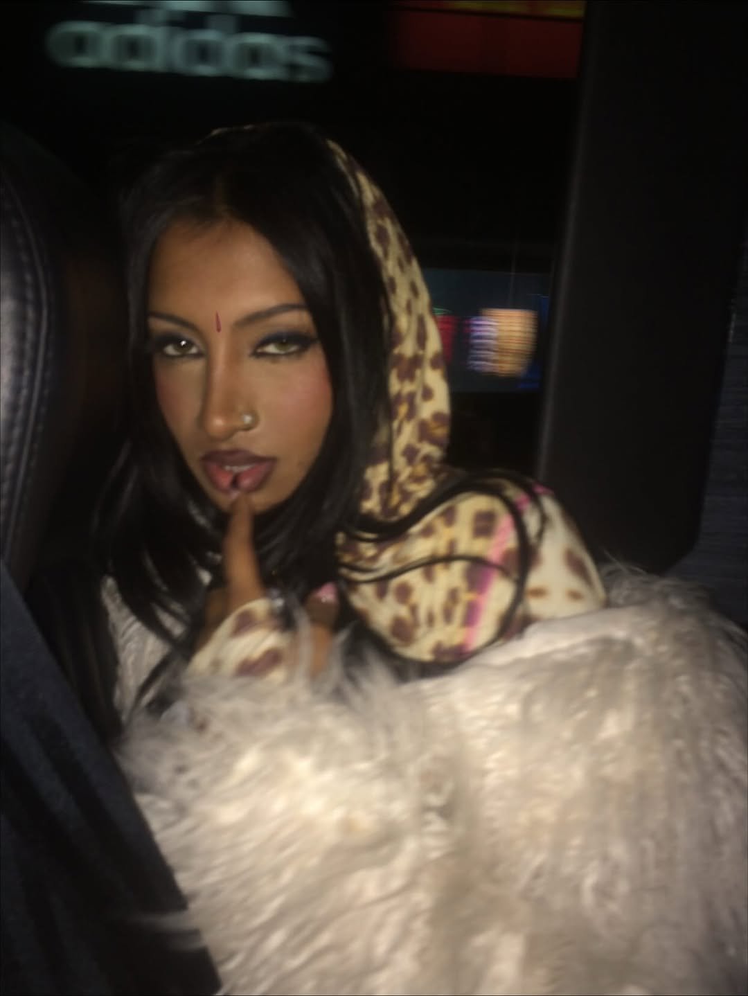 Photo by LARA RAJ on November 22, 2025. May be an image of one or more people, makeup, fur coat, turtleneck, parka, face mask and text.