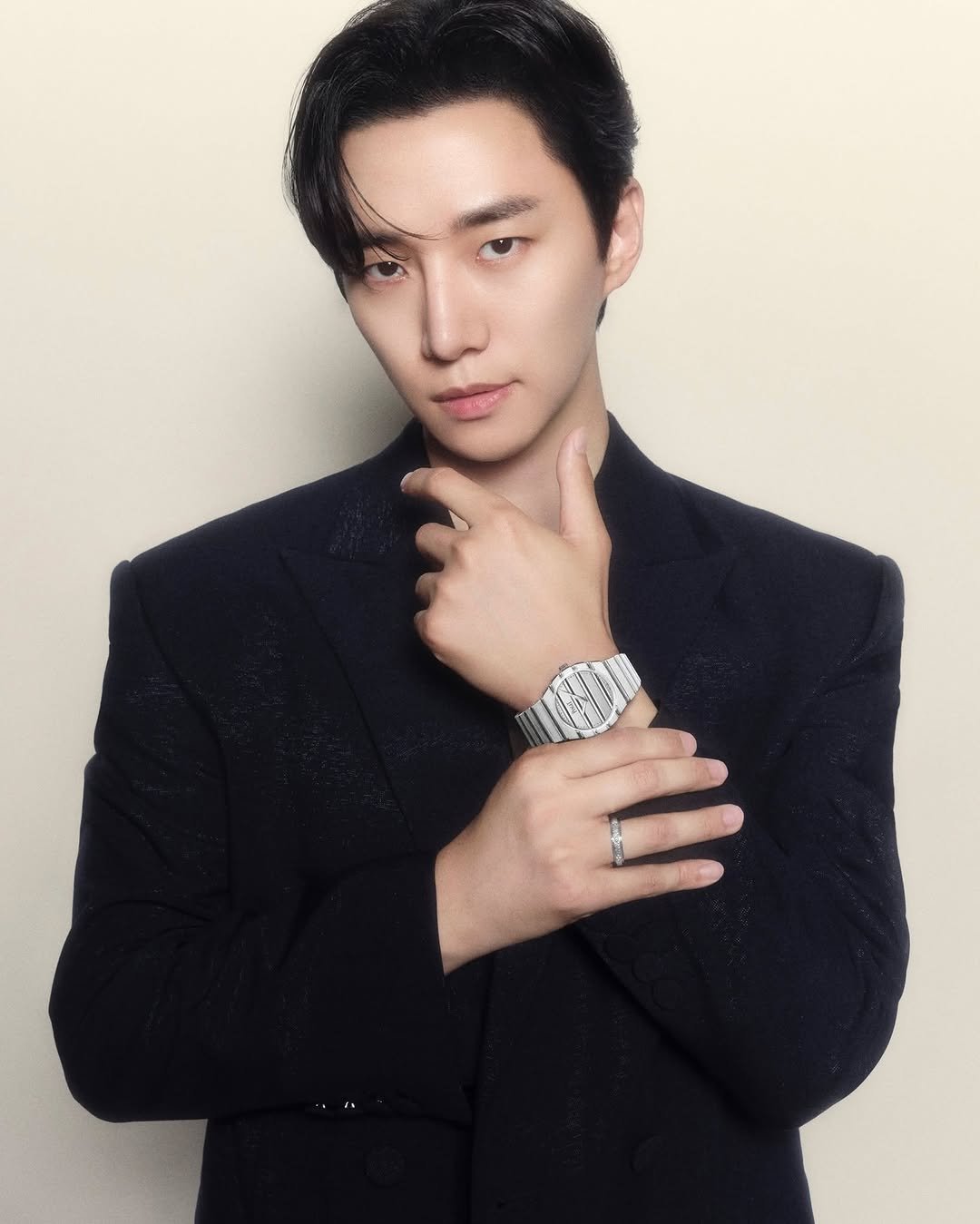 Photo shared by Piaget on October 16, 2025 tagging @le2jh. May be an image of one or more people, wrist watch, bolo tie, blazer and text.