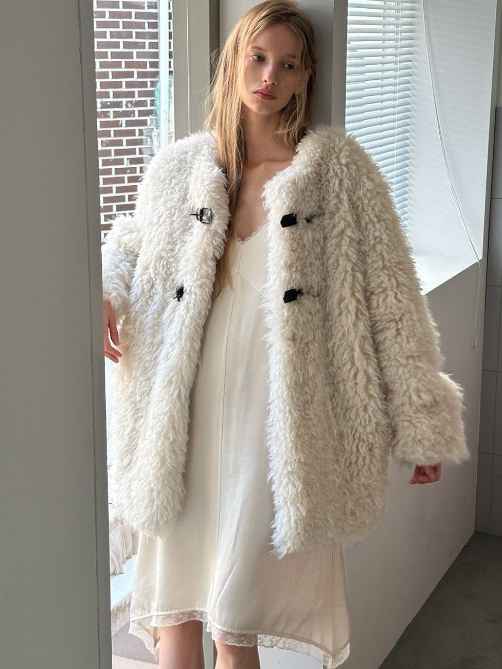 Photo by LECLE on November 03, 2025. May be an image of sable coat, overcoat, bath robe, robe and text.