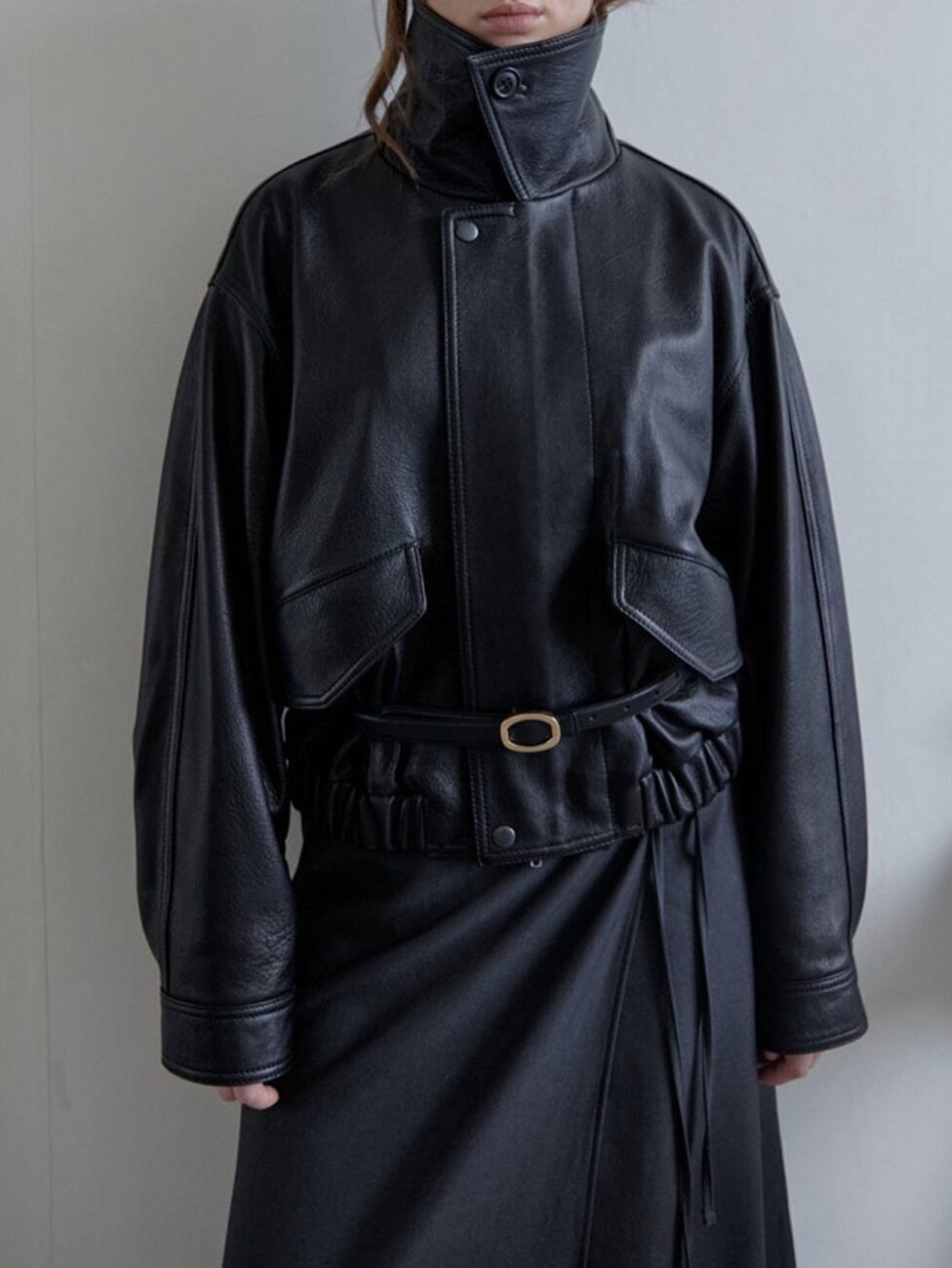 Photo by LECLE on October 15, 2025. May be an image of leather, overcoat, jacket, turtleneck and text.