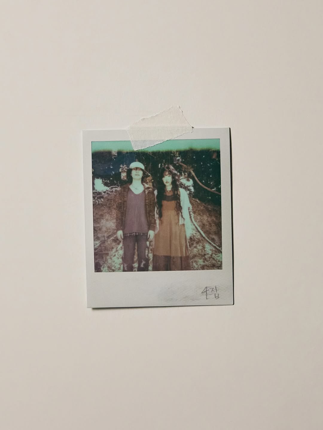 Photo shared by AKMU on February 23, 2026 tagging @leechanhyuk, and @akmu_suhyun. May be an image of polaroid and text that says '2 4잡'.