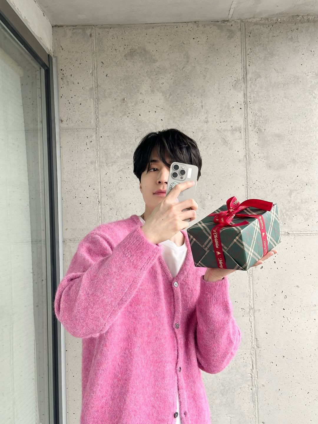 Photo by 이동욱 (Official_Instagram) on December 24, 2025. May be an image of duffle coat, sweater and text.