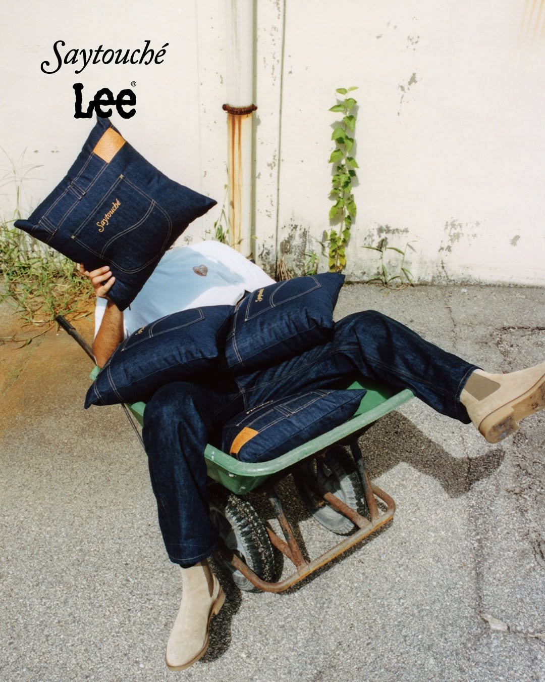 Photo shared by Lee Jeans KOREA on September 04, 2025 tagging @say_touche. May be an image of 1 person, beanbag chair and text that says 'Saytouché Lee UN'.