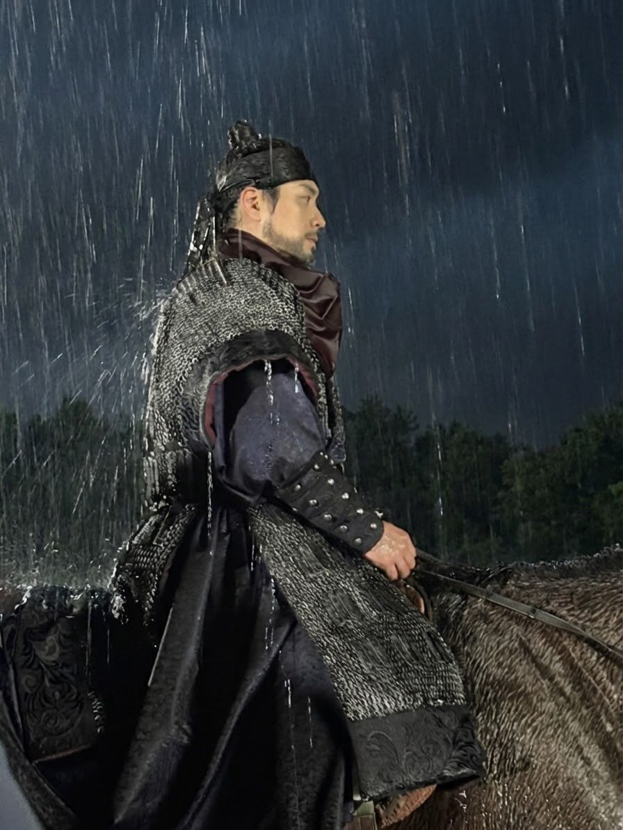 Photo by 이준혁 on February 24, 2026. May be an image of umbrella, cloak, costume, raincoat, sword and text.