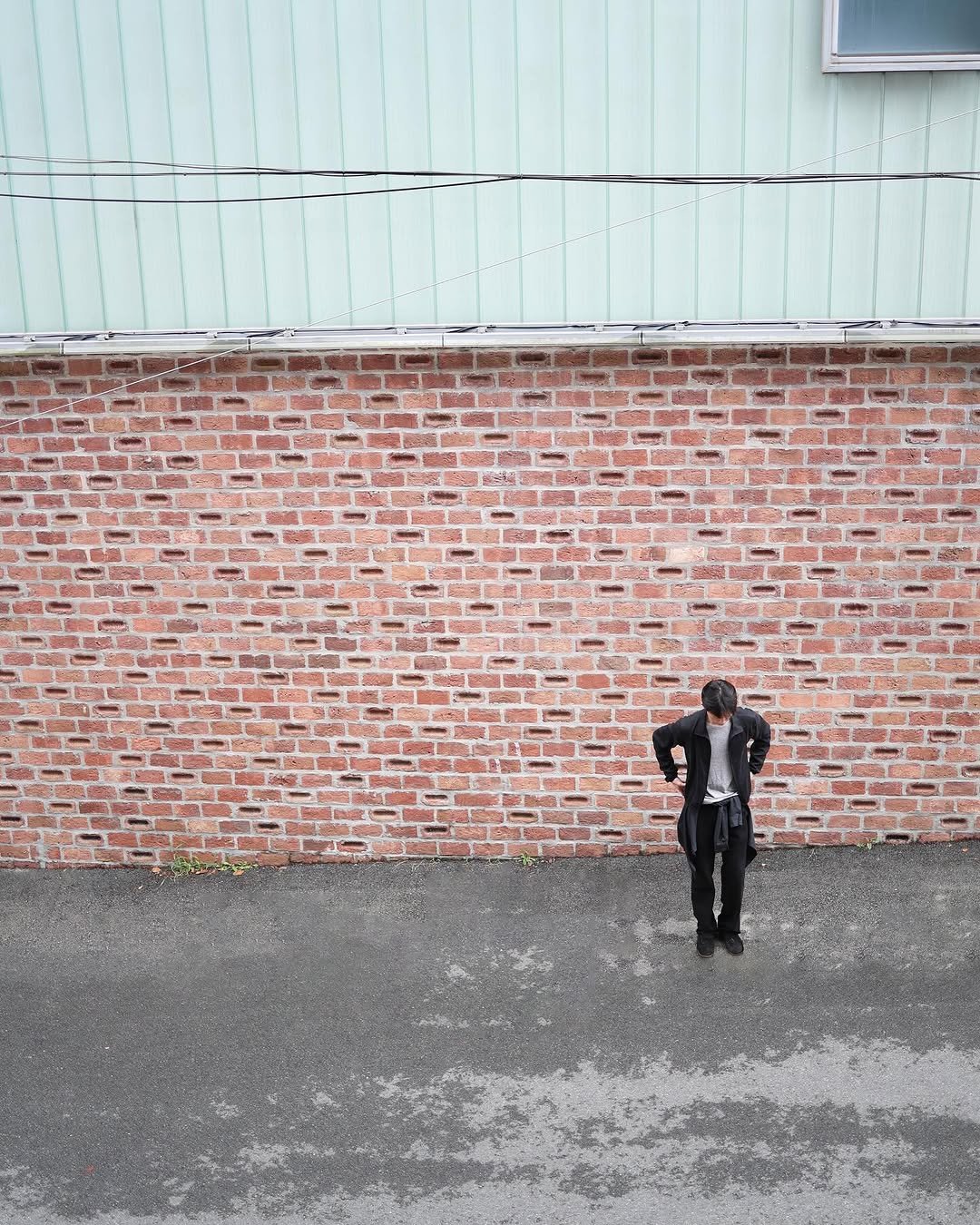 Photo by LES on October 16, 2025. May be an image of suit, brick wall and text.