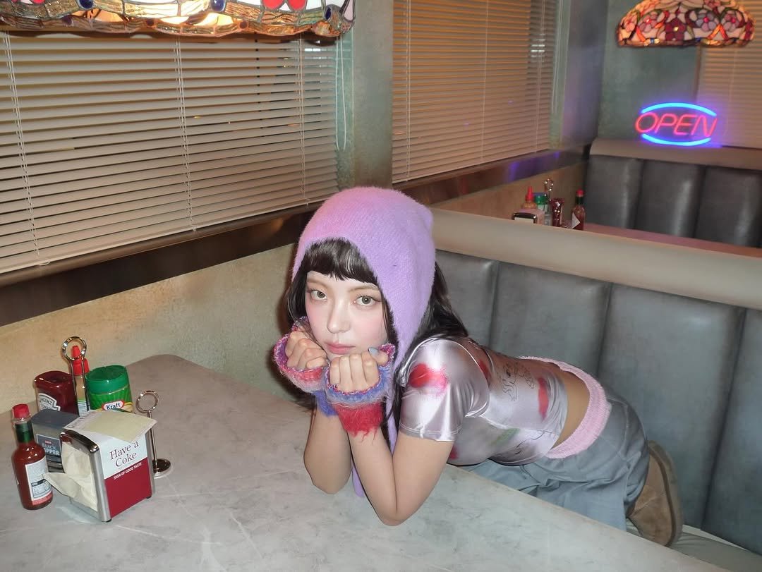 Photo by LIA on September 24, 2025. May be an image of miniskirt, beret, fishnet stockings and text.