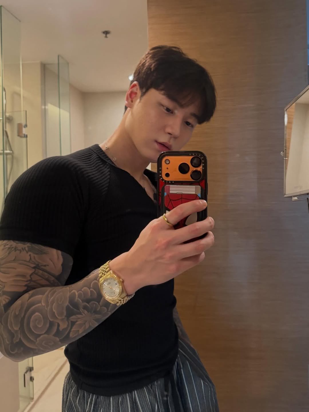 Photo shared by 종민 on April 12, 2026 tagging @kingpowerofficial. May be a selfie of one or more people, tattoo, biceps, sweatpants, mirror and text.