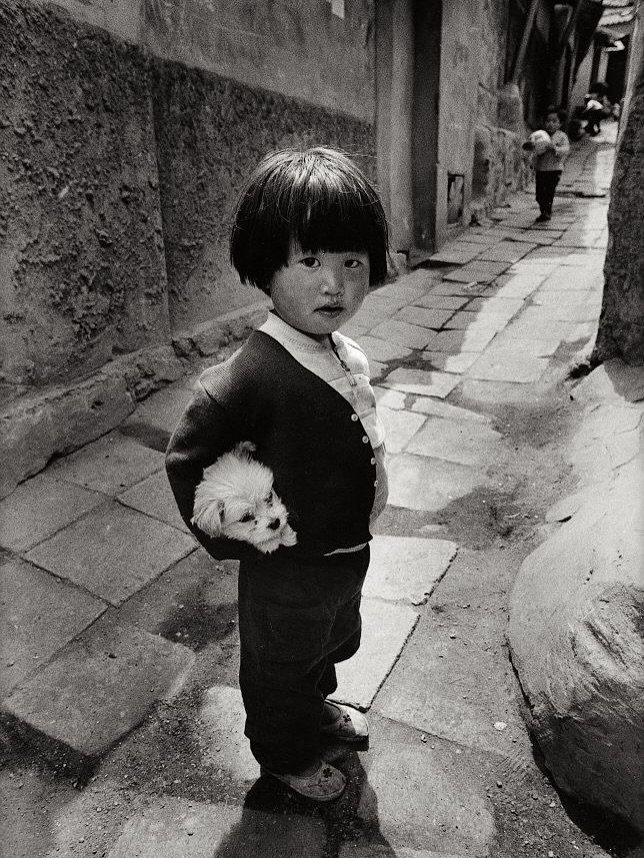 Photo by lolliesstreet on September 20, 2025. May be a black-and-white image of 2 people, child, people standing, street and text.