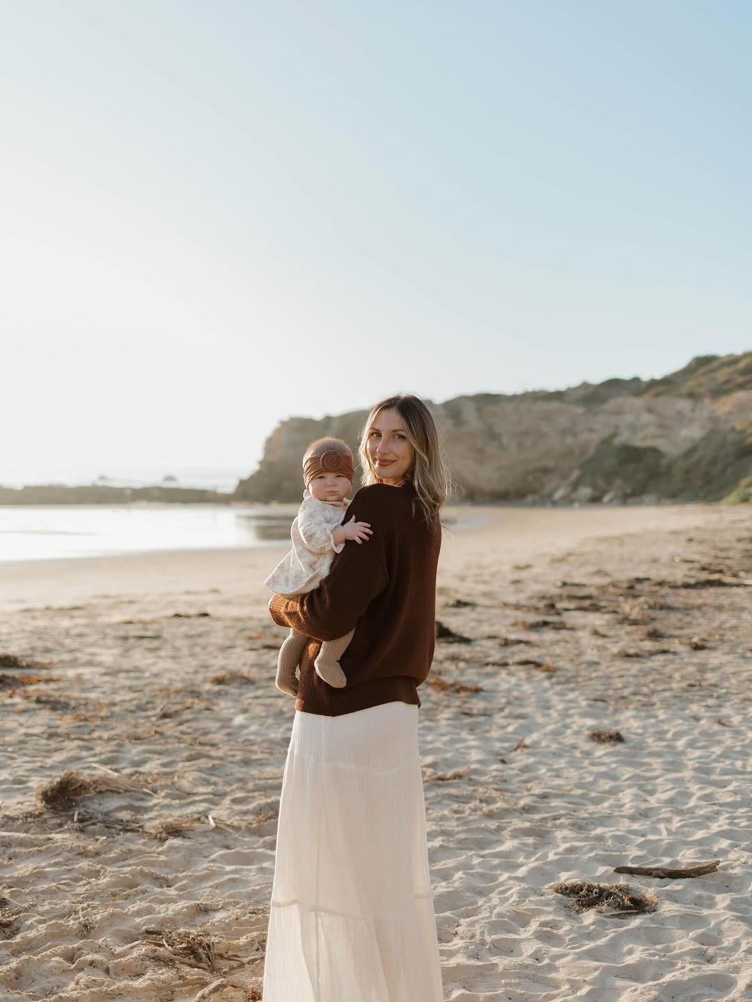 Photo shared by hannah kling on December 25, 2025 tagging @laurendaggettphoto. May be an image of baby, beach, ocean and text.