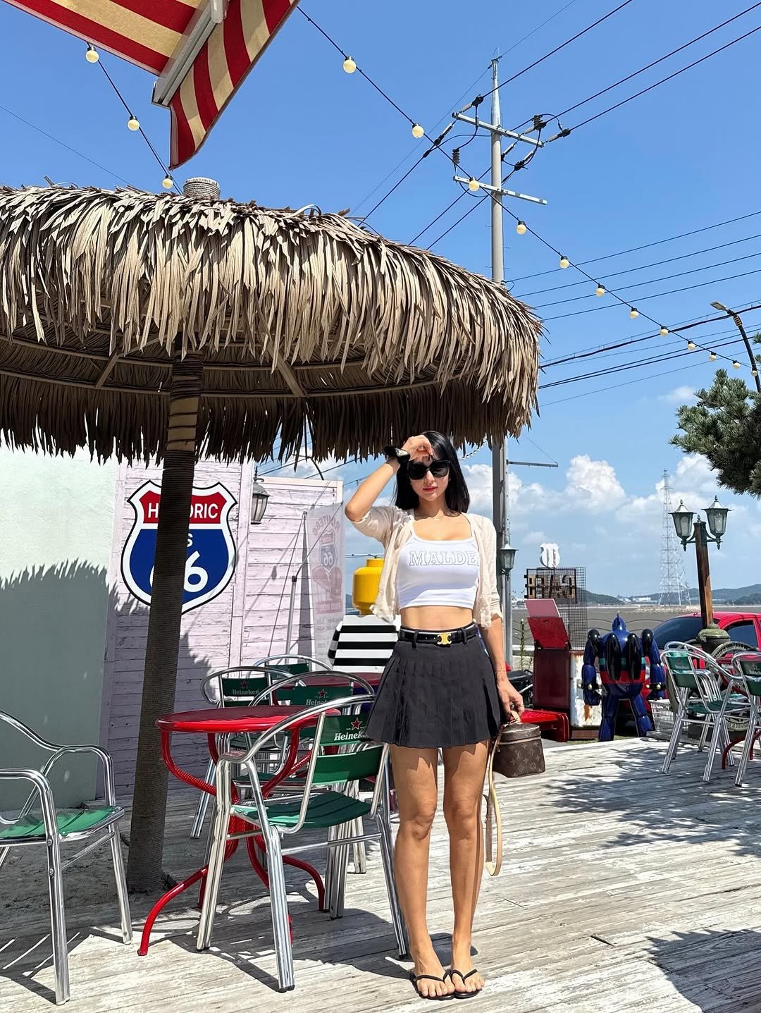 Photo shared by 러브썸진아 | 민진아 on September 07, 2025 tagging @route_66_jebu. May be an image of 4 people, miniskirt, parasol, shorts and text.