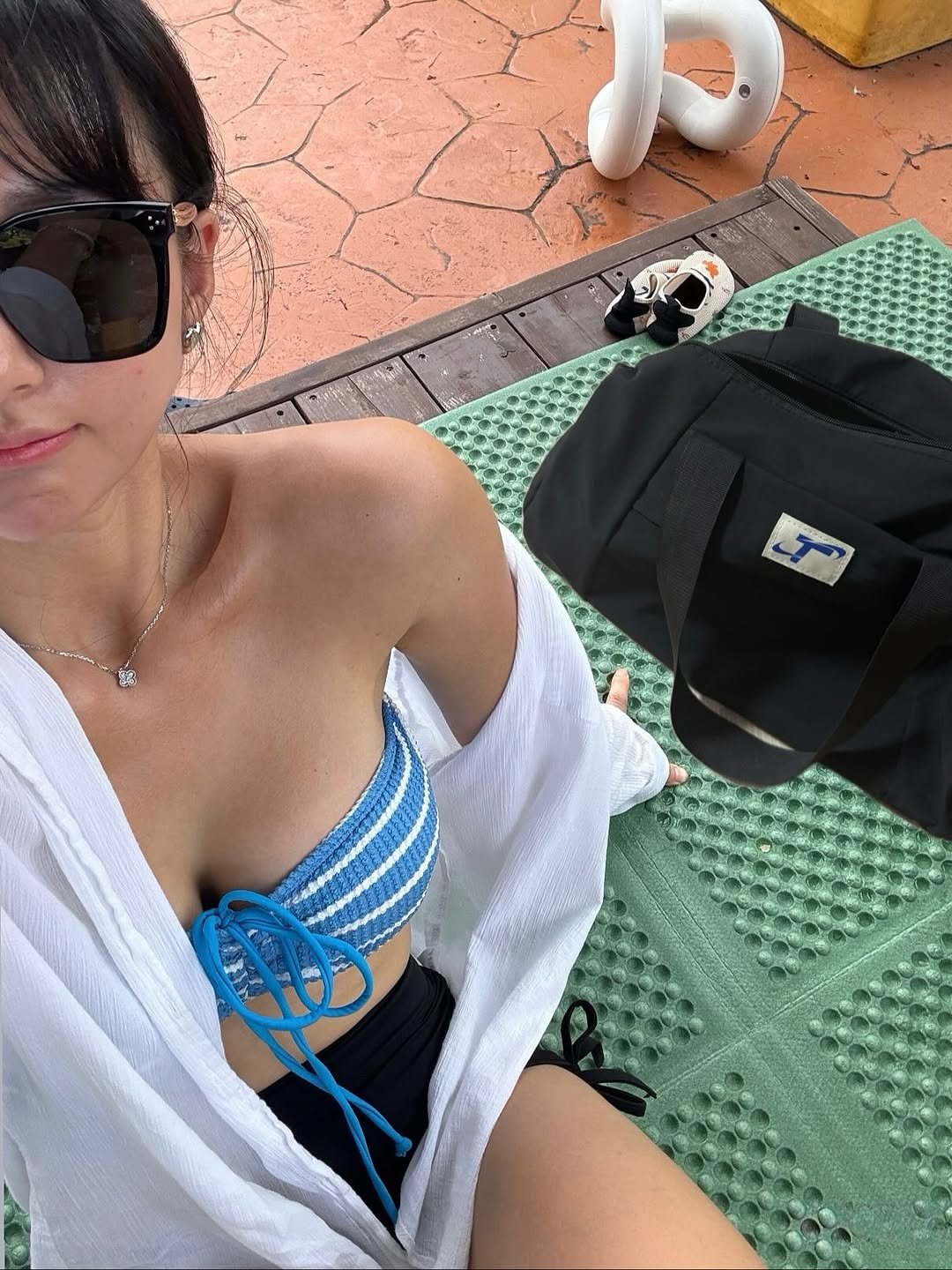 Photo shared by 러브썸진아 | 민진아 on August 29, 2025 tagging @thejoy_official. May be an image of 1 person, towel, deck chair, pool, cabana and text.