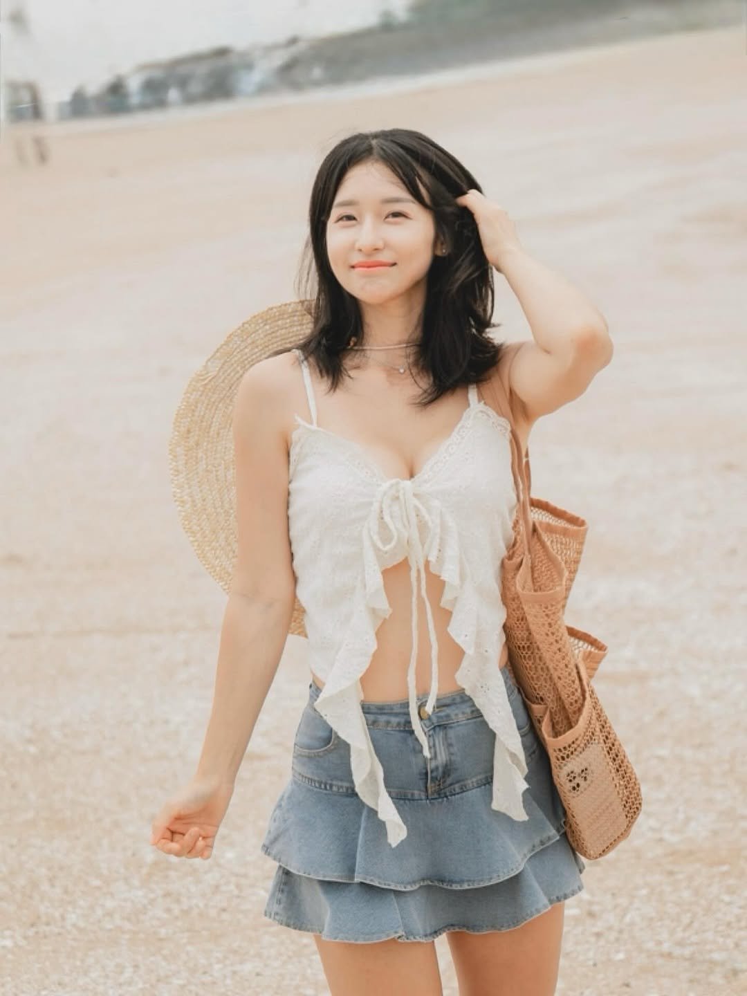 Photo by 러브썸진아 | 민진아 on August 18, 2025. May be an image of 1 person, top, sundress, beach and text.