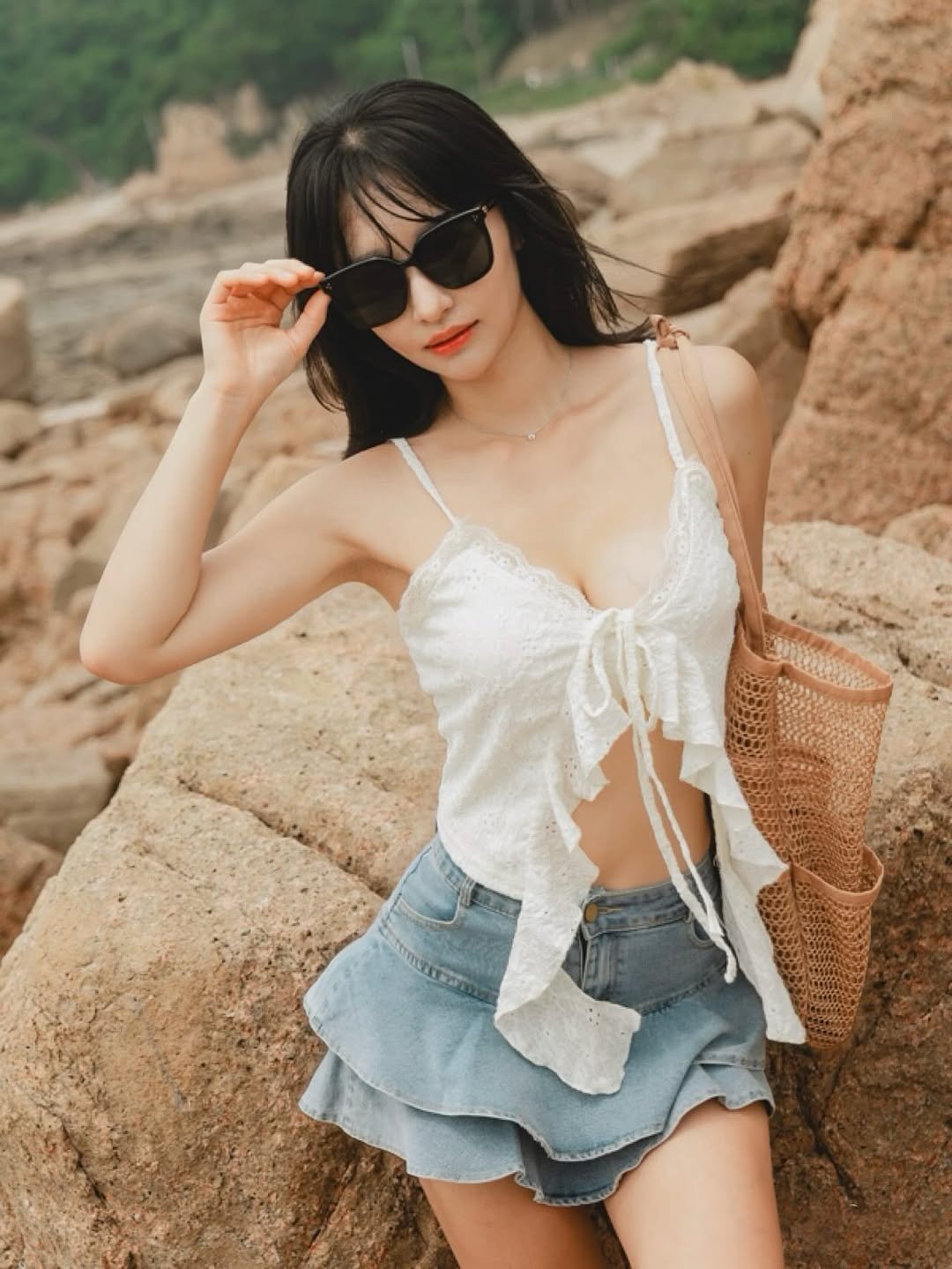 Photo by 러브썸진아 | 민진아 on August 25, 2025. May be an image of 1 person, eyewear, shorts, bra, top, miniskirt, beach and text.