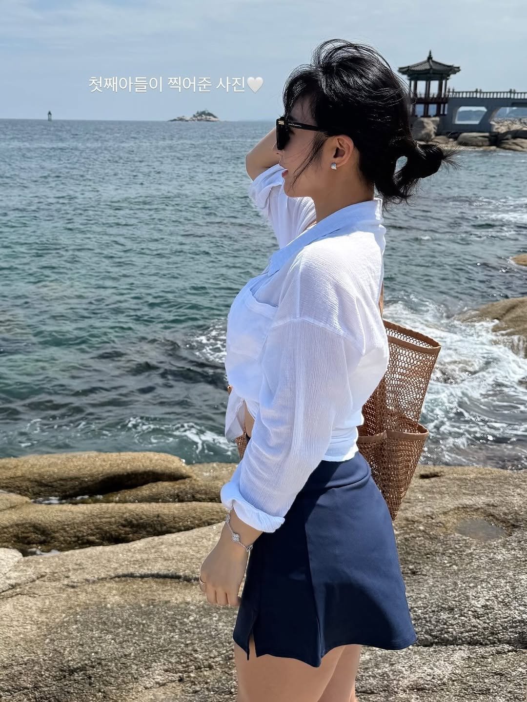 Photo by 러브썸진아 | 민진아 on August 24, 2025. May be an image of 1 person, miniskirt, ocean and text.
