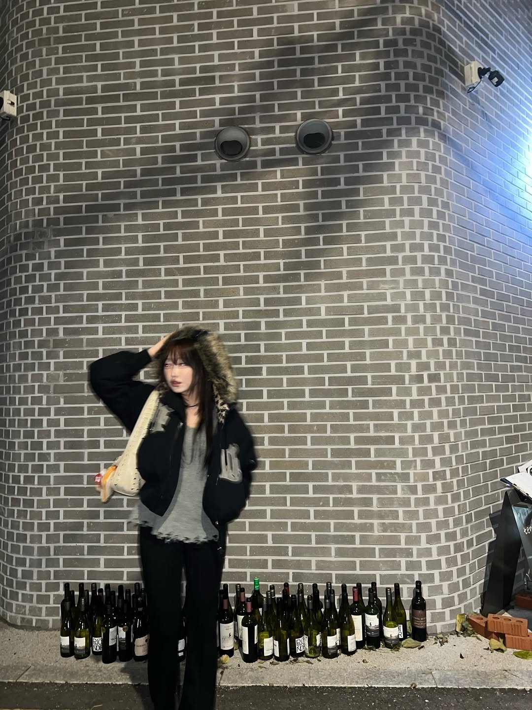Photo shared by 강예빈 on November 23, 2025 tagging @hoodhood_official. May be an image of champagne, wine glass, wine bottle, brick wall and text.