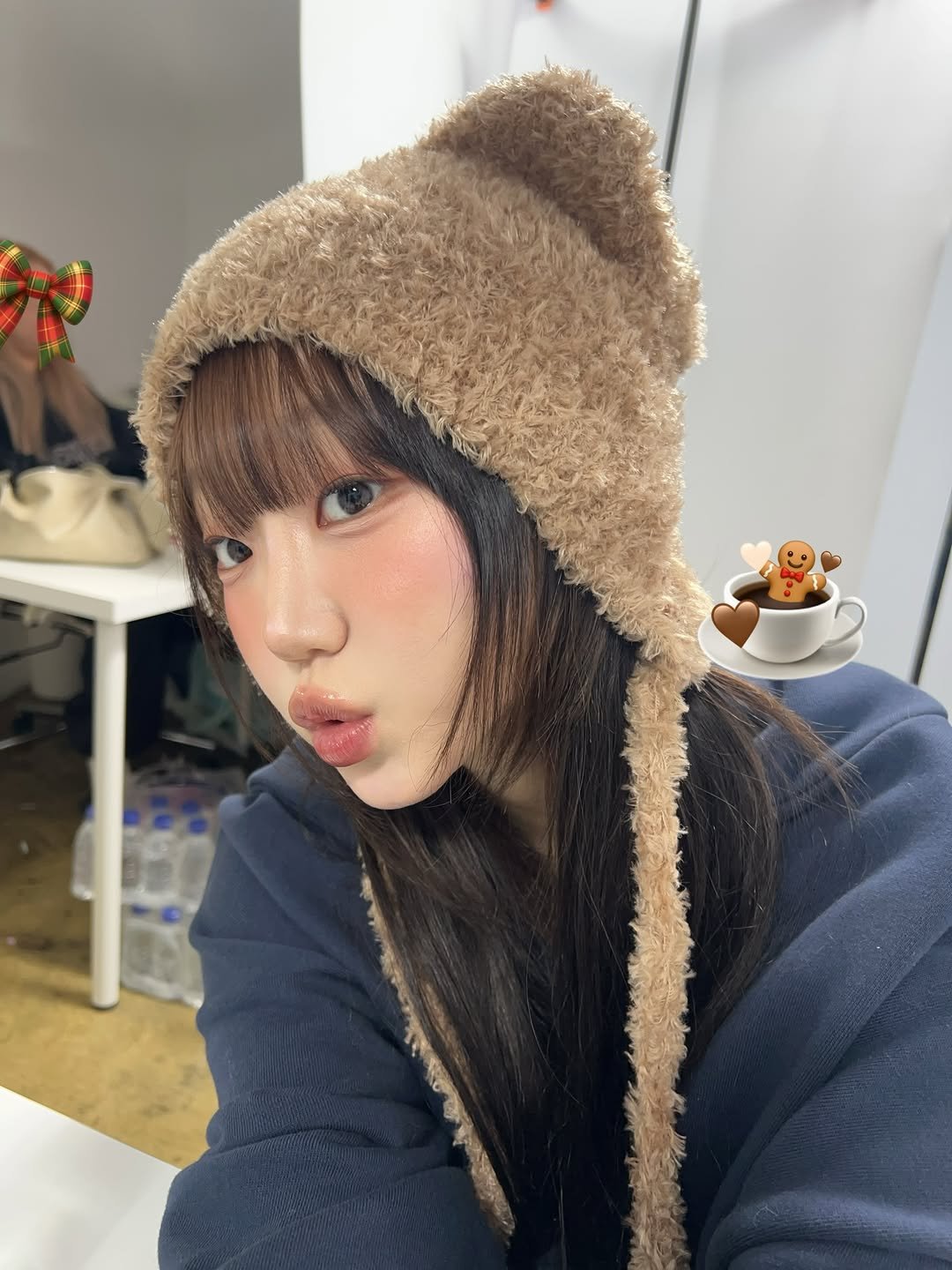 Photo by 강예빈 on December 21, 2025. May be an image of one or more people, hair, bear, duffle coat, hat, parka and text.