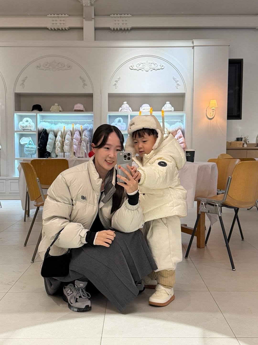 Photo shared by 이윤아 (태요미네) on November 08, 2025 tagging @newbalancelifestyle. May be an image of one or more people, duffle coat, overcoat, bath robe, parka and text.