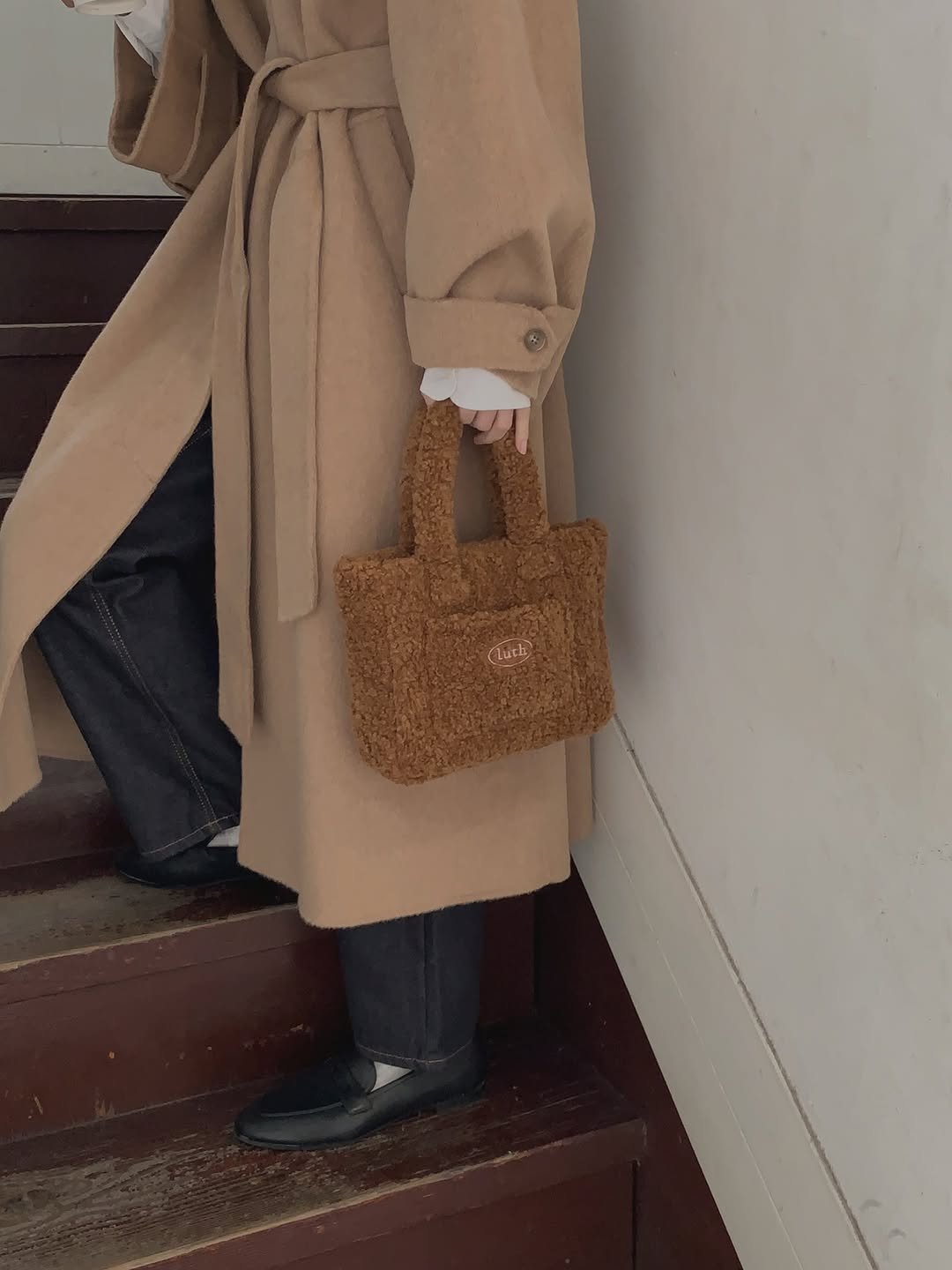 Photo by LUTH on December 05, 2025. May be an image of duffle coat, overcoat, wool and purse.