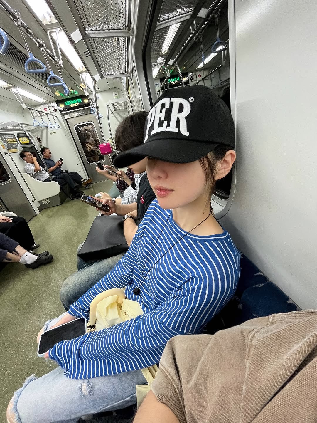 Photo shared by @제영 on August 14, 2025 tagging @permanent_archive. May be an image of 1 person, train, hat, bus and text.