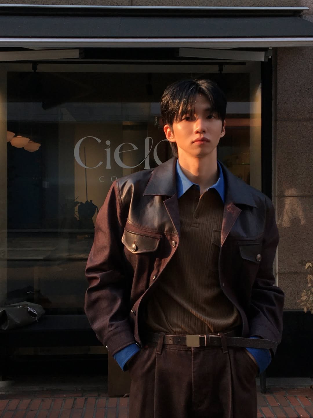 Photo shared by 배일리룩 Baeilylook on March 18, 2026 tagging @ungimmick_official. May be an image of duffle coat, overcoat, bolo tie, turtleneck, belt and text.